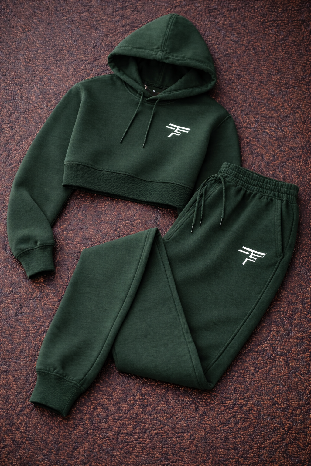 Green hoodie and jogger set with a logo on a brown textured background